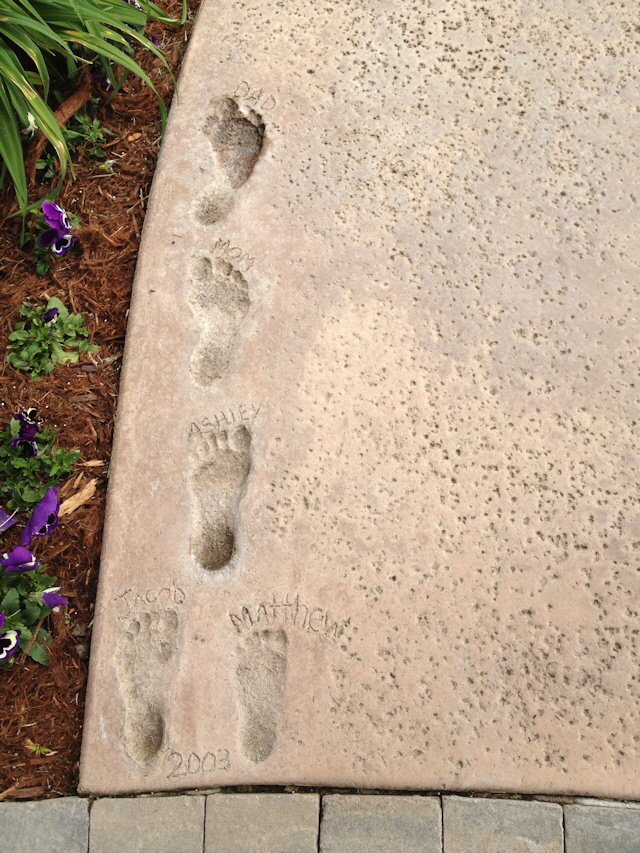 Foot prints in concrete pool deck.